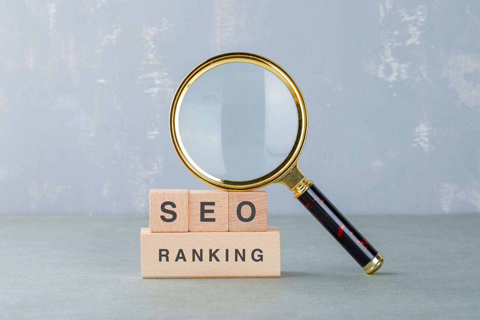 Conceptual of seo analysis and business. with wooden blocks with words on it, magnifying glass on sage color background side view. horizontal image SEO
